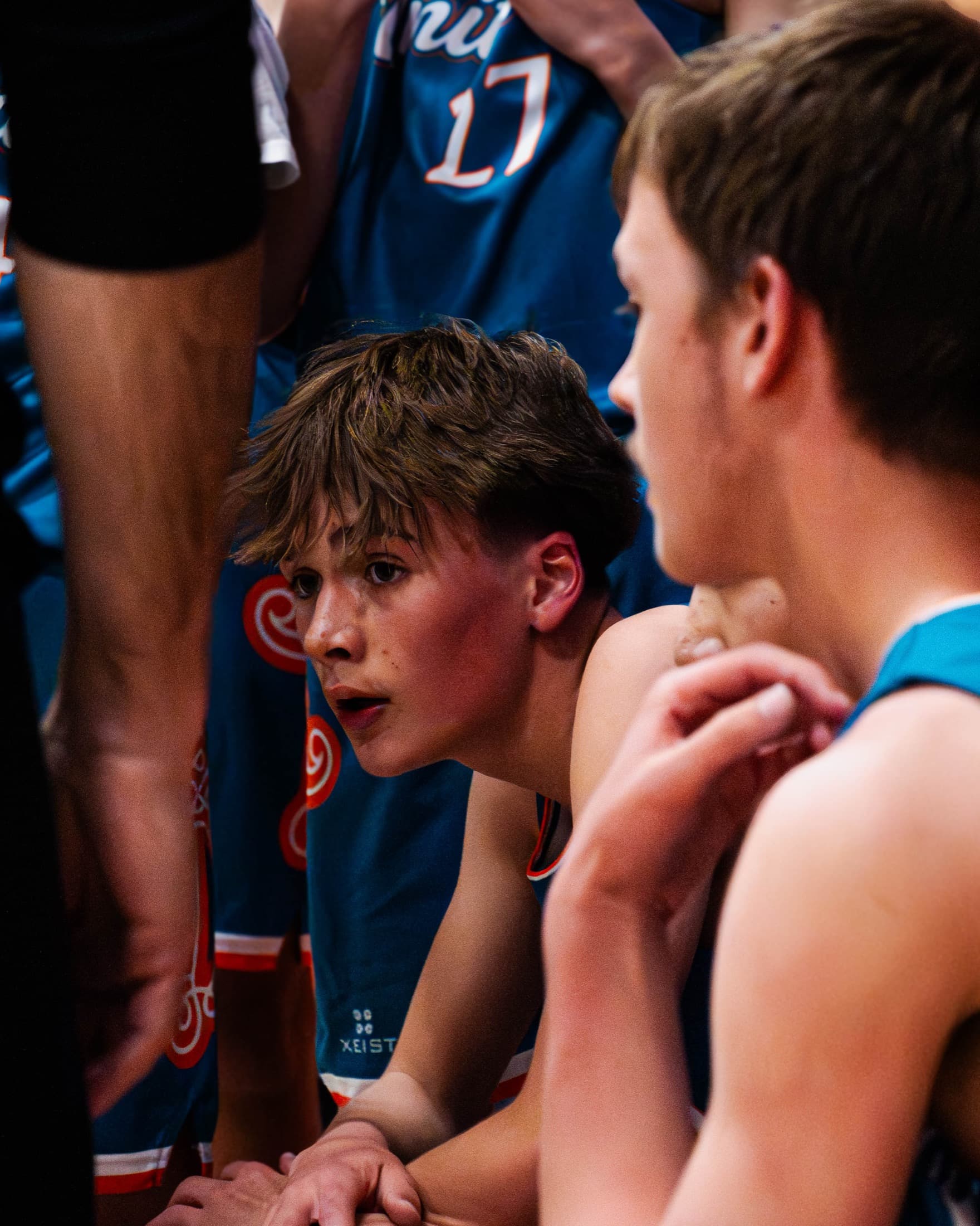 Players and coaches on the sideline during a game